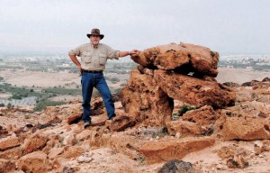 The author at a nearby dolman with Tall el-Hammam in the background. Photo courtesy Steven Collins.