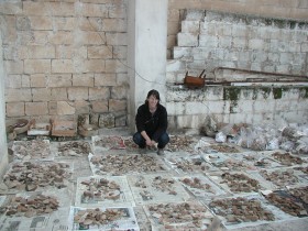 Sue Ann McCarty with a single day’s excavation worth of pottery.  Photo by Andy Creekmore.