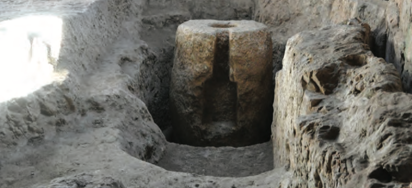 The oil press, showing two cross-shaped press frames in the eastern wall.